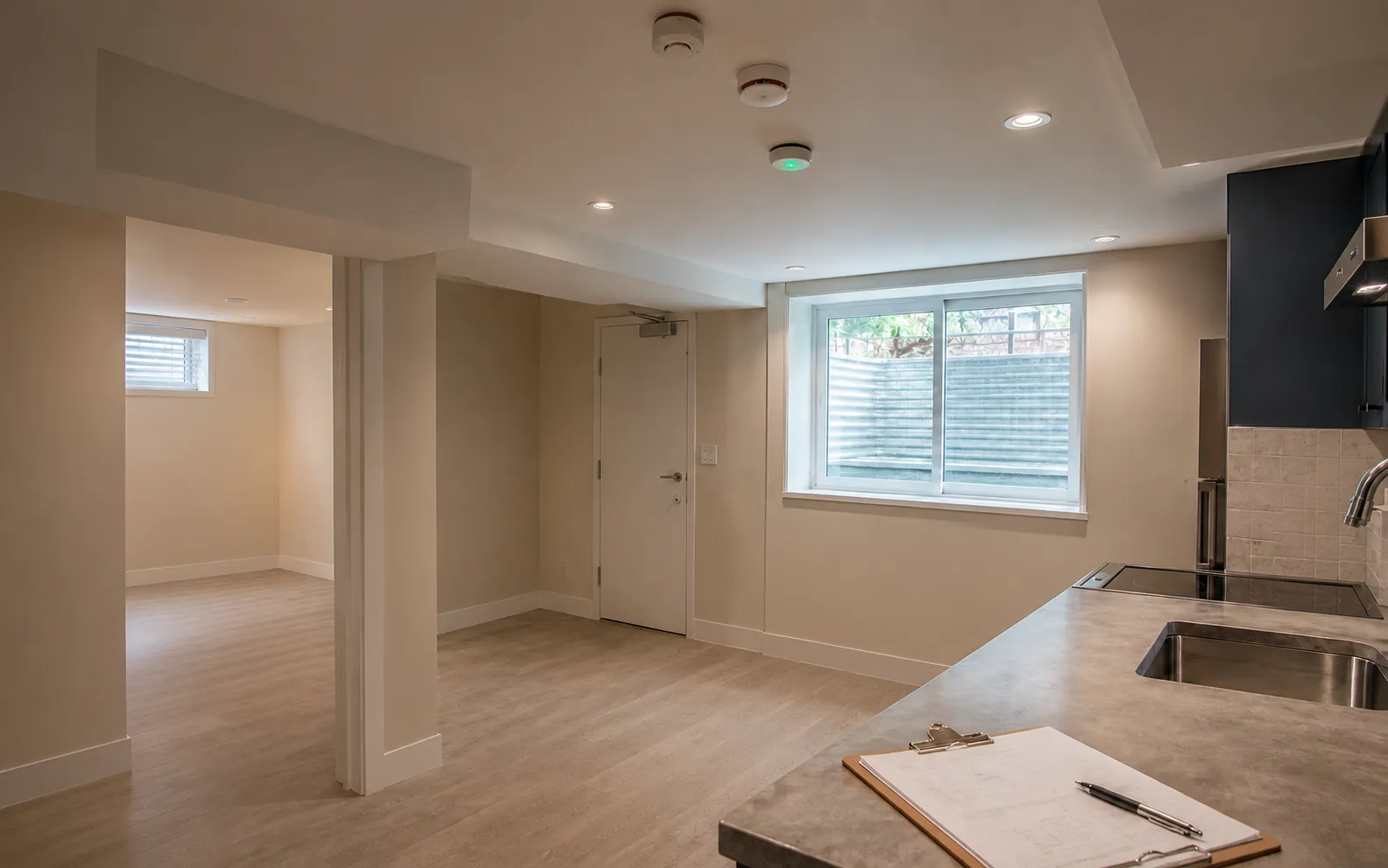 Minimalist legal basement apartment interior in an Ottawa home, brought up to current code with egress and permits